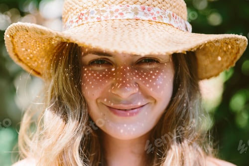 Preview: Portrait of a smiling woman. sunlight and straw hat shadow on her face.
Happy people. Summer mood