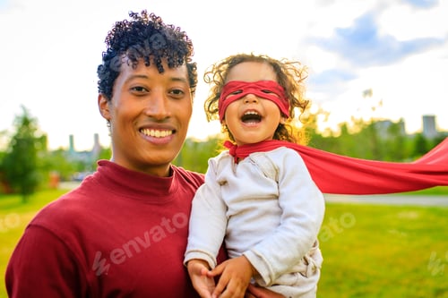 Preview: happy african american little fearless girl flying outdoor on father's hands in summer park
