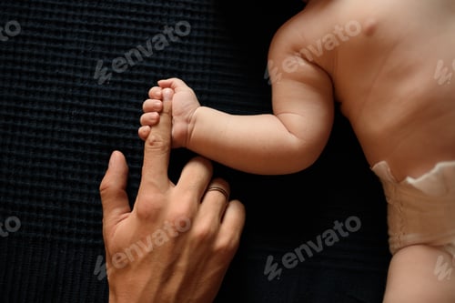 Preview: Little boy holds father by thumb