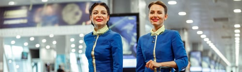 Preview: Joyful women stewardesses walking down airport terminal