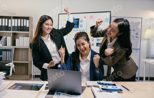 Preview: Three asian businesswomen are celebrating a successful business achievement in their modern office,