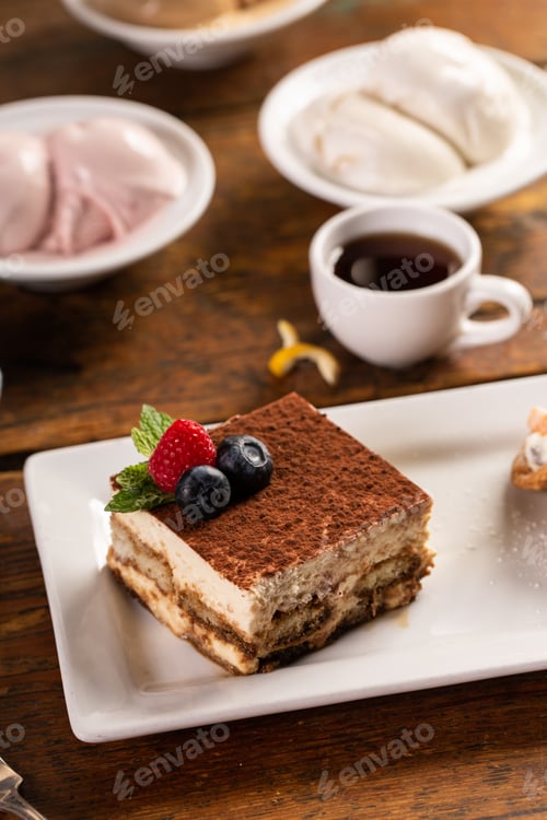 Preview: Tiramisu dessert served on a white plate with espresso