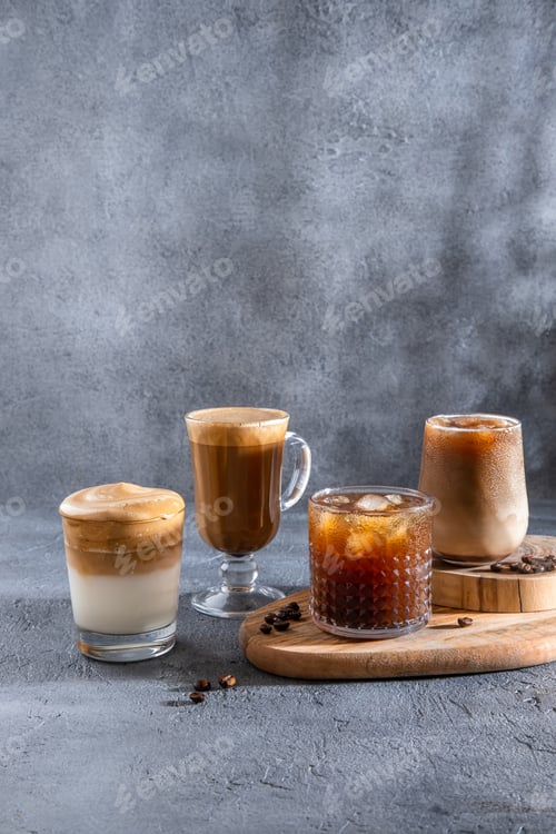 Preview: Ice coffee in a tall glass with cream poured over and coffee beans.