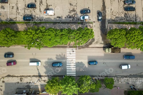 Preview: Top down aerial view of busy street with moving cars traffic and zebra road pedestrian crosswalk.