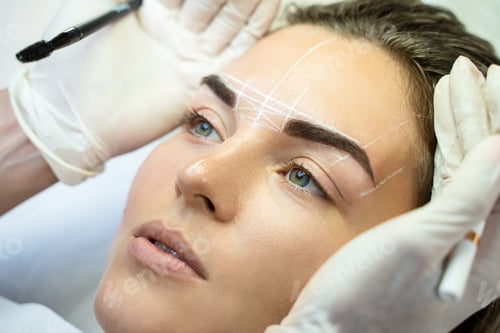 Preview: Woman during professional eyebrow mapping procedure