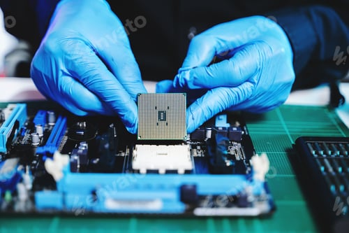 Preview: The technician is putting the CPU on the socket of the computer motherboard.