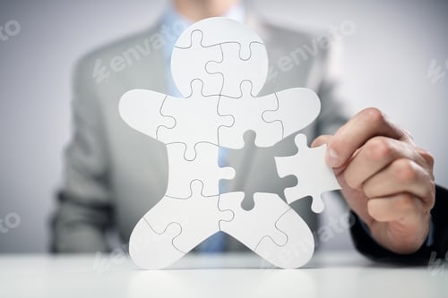 Preview: Businessman assembling jigsaw puzzle human team employee