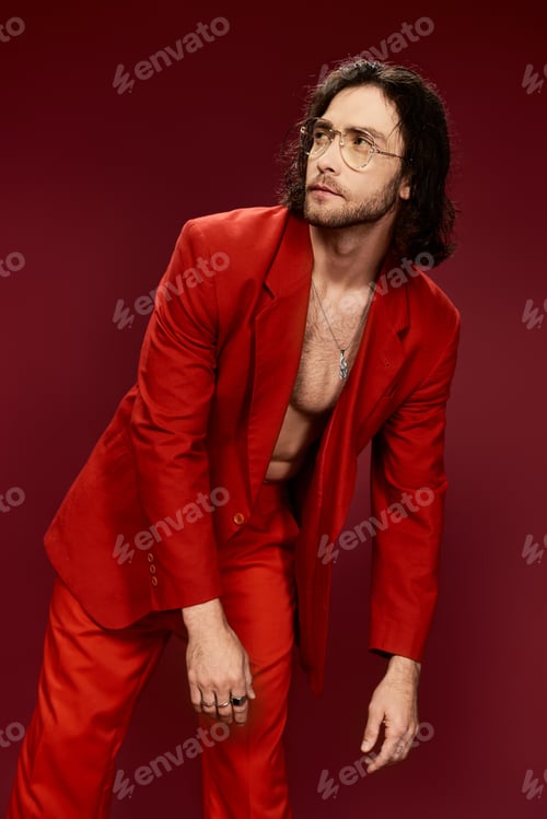 Preview: Dapper gentleman donning red suit strikes elegant pose