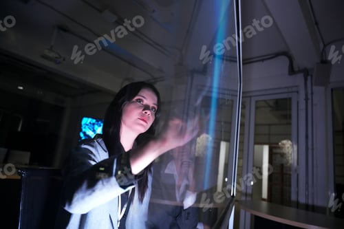 Preview: Woman interacts with a digital display in a modern office setting