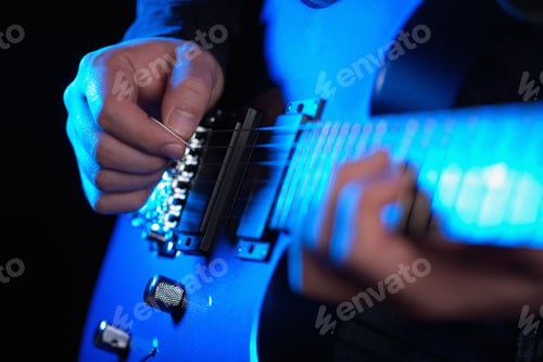 Preview: musician rock guitarist playing a blue guitar