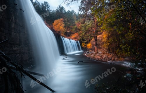 Preview: Amazing waterfall between autumn forest