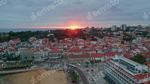 Preview: Serene sunset coastal city drone view. Beautiful horizon glowing orange light