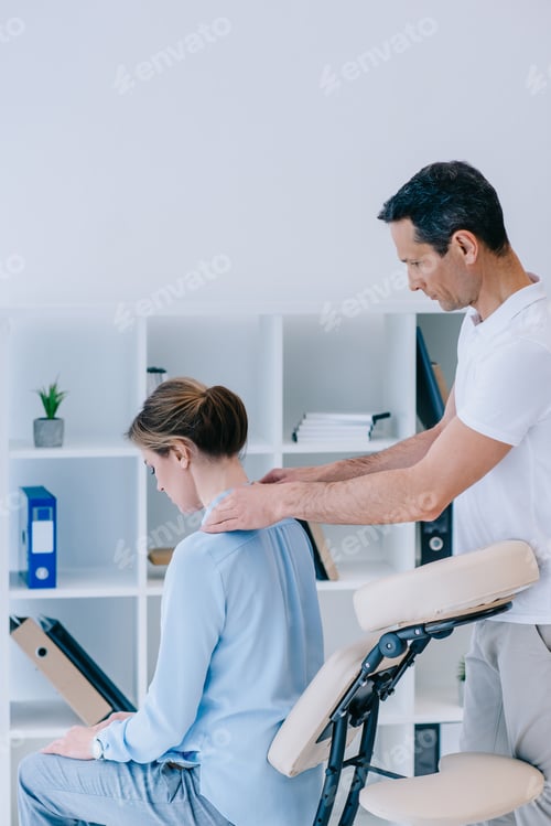 Preview: masseur massaging shoulders of female client