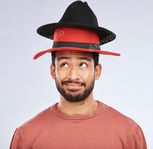 Preview: Confused, hats and young man in a studio with a thinking, idea or contemplating face expression. Pe