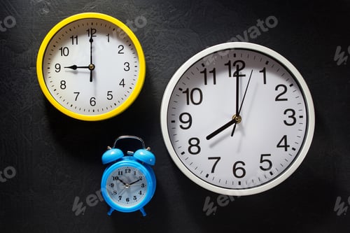 Preview: wall and alarm clock at black background