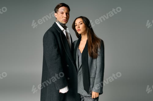 Preview: Stylish young couple posing in modern attire with a chic minimal backdrop at an indoor location