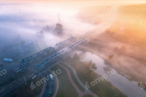Preview: Aerial view of beautiful railroad bridge and river in fog in fall