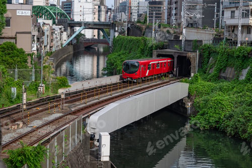 Preview: a passenger train riding along on the train tracks near a city