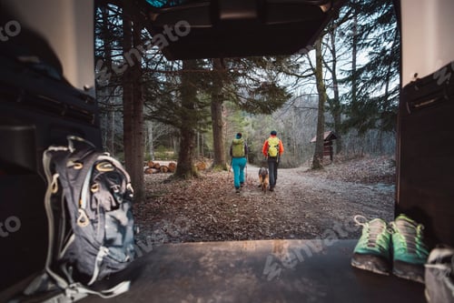 Preview: Man and woman going on a hike in Californian mountains in early morning. Packing at the back of her