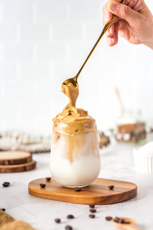 Preview: Dalgona coffee with fluffy cream served on wood tray.Homemade trendy beverage menu on social media