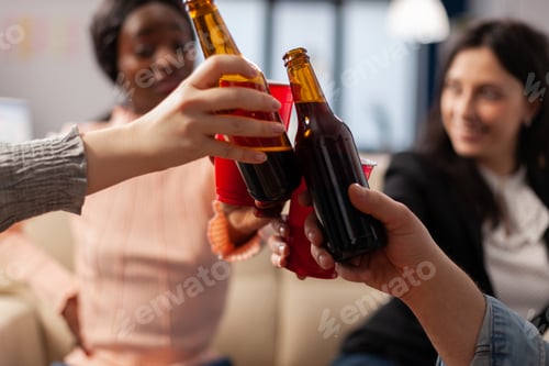 Preview: Close up of bottles and cups of beer from cheerful friends