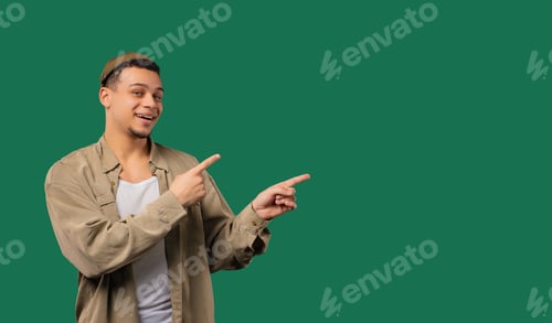 Preview: Stylish smiling multiracial man pointing right side, copy space or advertising.