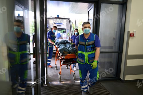 Preview: Team of paramedics delivered gurney with patient to emergency room