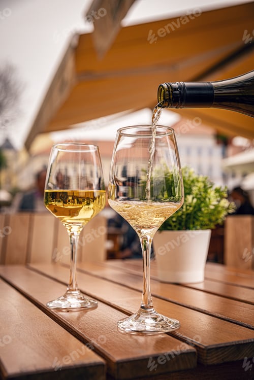 Preview: Glass is being filled with white wine