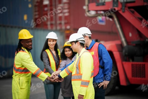 Preview: Teamwork among diverse workers in safety gear at a warehouse during the day
