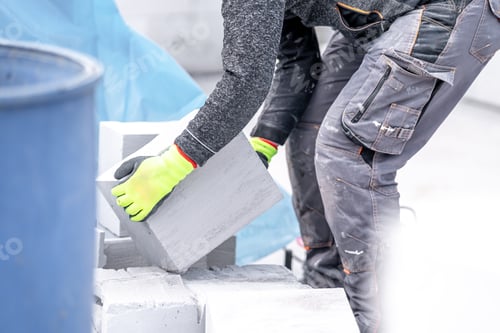 Preview: craftsman builds a house from concrete bricks