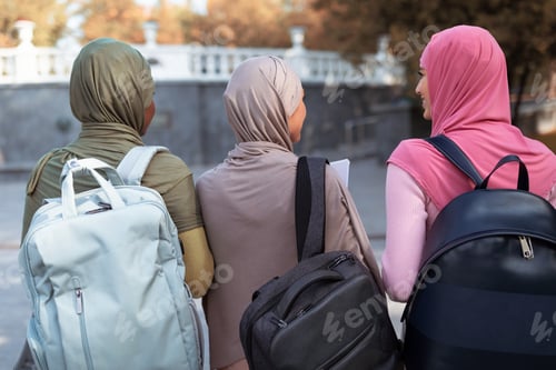Preview: Three Muslim Ladies With Backpacks Walking Back To Camera Outdoor