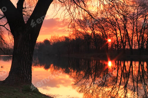 Preview: The first rays of the rising sun at misty river