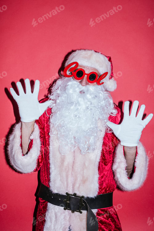 Preview: Man dressed as Santa Claus gesturing with funny glasses