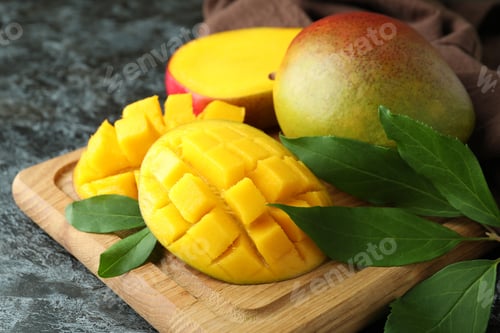 Preview: Tasty ripe mango fruit on black smokey table