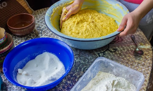 Preview: the girl kneads the dough in a bowl. selective focus