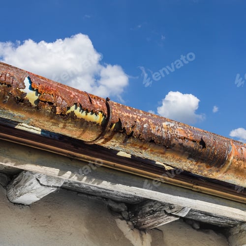 Preview: Broken gutter on the roof of a house