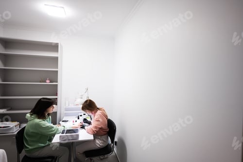 Preview: Manicure master working with female client in beauty salon. Manicurist makes woman nail.