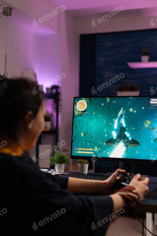 Preview: Gamer playing video games with joystick on monitor