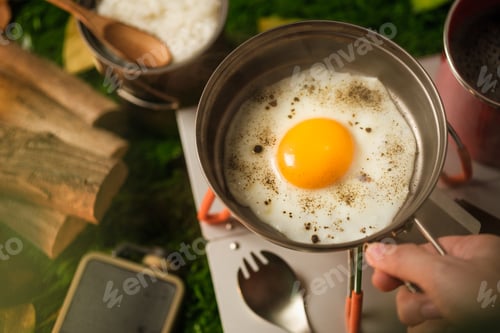 Preview: close up hand fried egg on pan when campping in holiday vacation