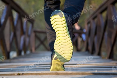 Preview: Runner feet running at park closeup on shoe