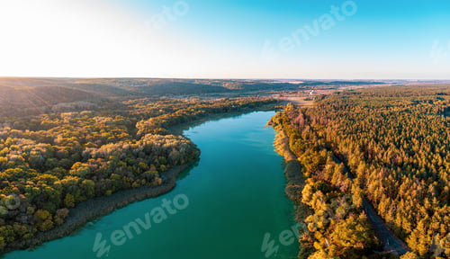 Preview: River curves running across dense forests at bright sunrise