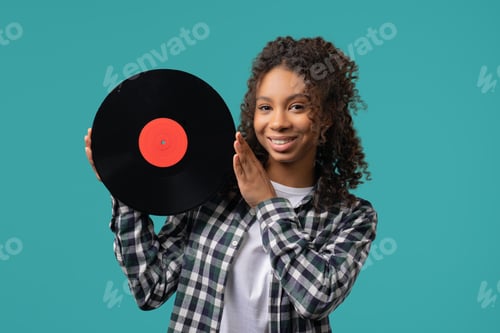 Preview: Young african teenager girl with vinyl record disc. Hobby,Music Lover,Collection
