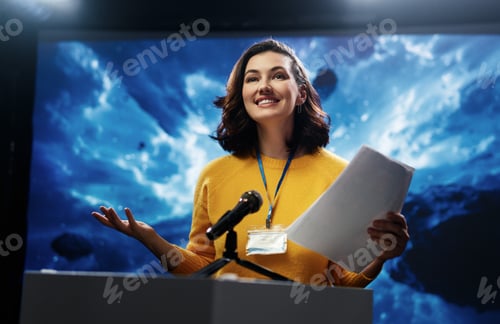 Preview: Smiling Woman Giving Speech at Business Conference