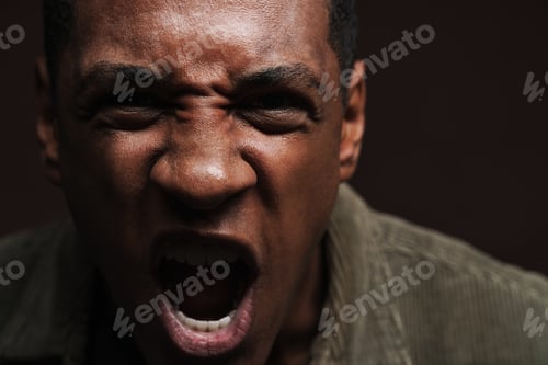 Preview: Young black man frowning and screaming at camera