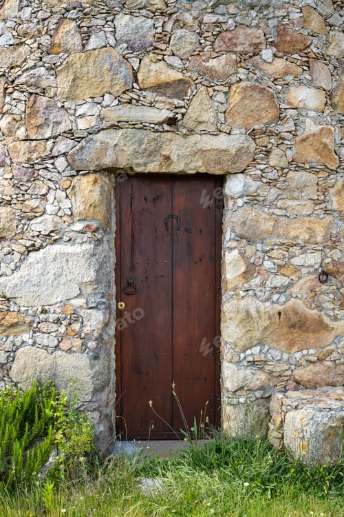 Preview: Old wooden door and stone wall