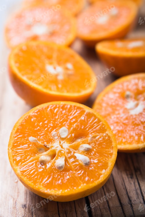 Preview: Fresh juisy chopped orange half pieces or tangerine food background