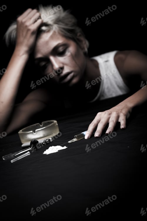 Preview: Young female drug addict on black background.