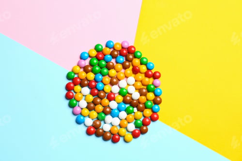 Preview: Delicious bright glazed candies on color background, top view