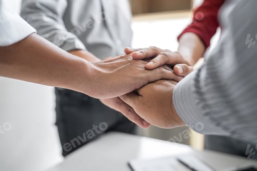 Preview: Image of business people joining and putting hands together during their meeting