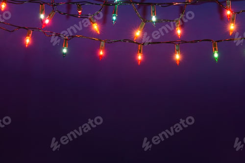 Preview: Christmas lights string on blue background with copy space